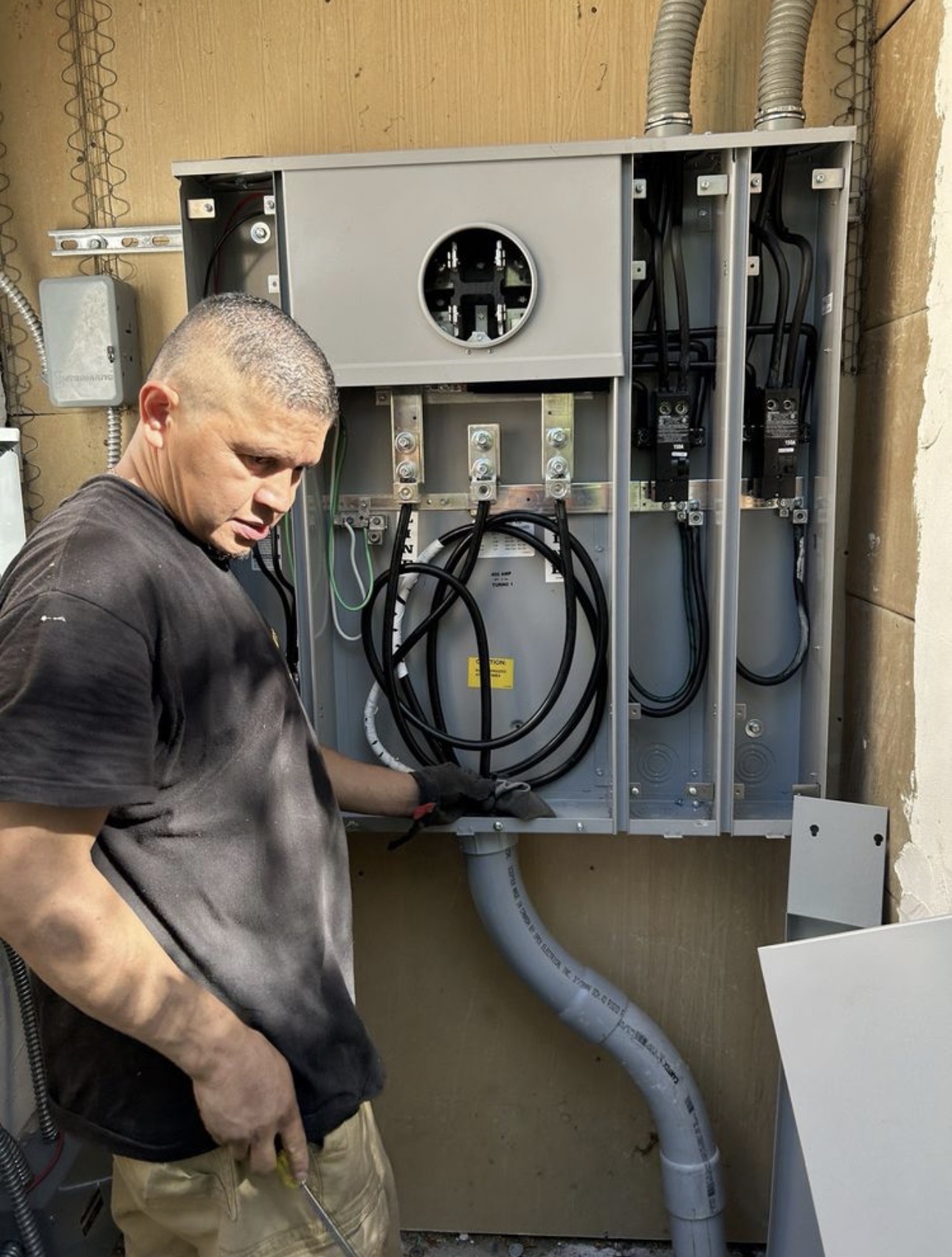 Jhony Mena of JEM Electrical wiring a 400-amp service panel